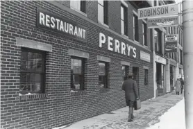  ?? T&G FILE PHOTO ?? The building at 134 Main St. is gone. So, too, is the sign for Robinson Place, which amounted to an alley between 144 Main St., still standing, and 134 Main St.