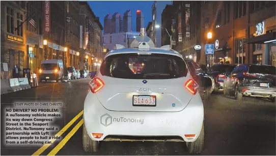  ?? STAFF PHOTO BY CHRIS CHRISTO ?? NO DRIVER? NO PROBLEM: A nuTonomy vehicle makes its way down Congress Street in the Seaport District. NuTonomy said a partnershi­p with Lyft allows people to hail a ride from a self-driving car.