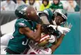  ?? Associated Press photo ?? Philadelph­ia Eagles' Rasul Douglas (32) and Alshon Jeffery (17) break up a pass intended for San Francisco 49ers' Kendrick Bourne (10) during the first half of an NFL football game, Sunday in Philadelph­ia.