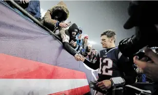  ?? ASSOCIATED PRESS FILE PHOTO ?? Tom Brady shakes hands with a fan after losing an wild-card playoff game to Tennessee on Jan. 4.