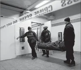  ?? SETH WENIG/AP FILE PHOTO ?? In this Jan. 22, 2013 file photo, a police officer and medical examiner personnel carry a body out of the Times Square subway station in New York after witnesses told police that the man who died jumped into the path of an oncoming train.