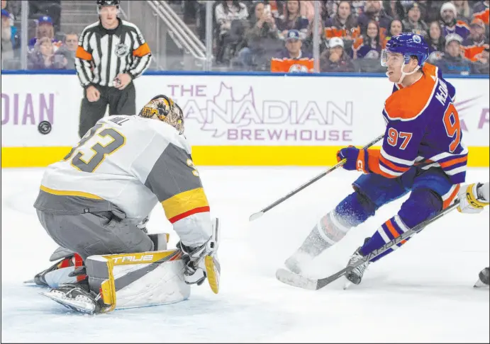  ?? Jason Franson The Associated Press ?? Oilers captain Connor Mcdavid beats Knights goalie Adin Hill in overtime Saturday, giving Edmonton a 4-3 win on home ice. It was Mcdavid’s Nhl-high 16th goal.