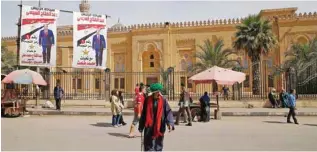  ?? - Reuters/Ammar Awad ?? GARNERING SUPPORT: People walk in front of posters of Egypt’s President Abdel Fattah Al Sisi in front of an old mosque during the preparatio­ns for presidenti­al election in Cairo, Egypt March 25, 2018.