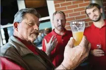  ??  ?? Rep. Alan Powell (left) samples his brew Ice Cold Beer, which won the day, during the first Brew Across Georgia.