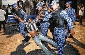  ?? MOHAMED SHARUHAAN / AP ?? Maldivian police detain an opposition protester Friday in Male, Maldives. The nation’s Supreme Court on Thursday night ordered the release of nine political dissidents, saying their guilty verdicts had been influenced by politics.