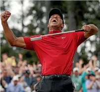  ?? AP ?? Tiger Woods celebrates after sinking his putt to win on the 18th green during the final round of the Masters.