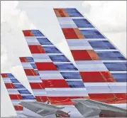  ?? ALAN DIAZ / ASSOCIATED PRESS ?? American Airlines Group Inc. reported that net income jumped 80 percent to $1.69 billion thanks to a huge drop in fuel spending. Beginning next year American said it will offer tickets with “less frills.”