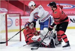  ?? SEAN KILPATRICK/CANADIAN PRESS VIA AP ?? Montreal Canadiens center Nick Suzuki (14) gets tangled up with Ottawa Senators goaltender Matt Murray (30) as Senators defenseman Thomas Chabot (72) looks for the puck in Ottawa on Saturday.