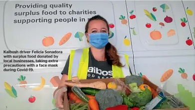  ??  ?? Kaibosh driver Felicia Sonadora with surplus food donated by local businesses, taking extra precaution­s with a face mask during Covid-19.