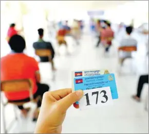  ?? HONG MENA ?? People wait for their turn to get vaccinated against Covid-19 in Phnom Penh.