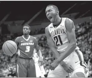  ?? AP/JULIO CORTEZ ?? Villanova forward Dhamir Cosby-Roundtree (right) reacts after dunking on Hofstra during the Wildcat’s 95-71 victory Friday in Uniondale, N.Y. Villanova remains the top team in The Associated Press men’s top 25 poll.