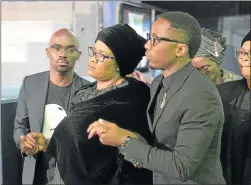  ?? Picture: GALLO IMAGES ?? SAD FAREWELL: Zoleka Jezile, centre, is supported by Musa Mthombeni, left, and Andile Ncube, right, during the memorial service of her late son Akhumzi Jezile at the Rhema Bible Church on Thursday in Randburg. Jezile was described as assertive,...