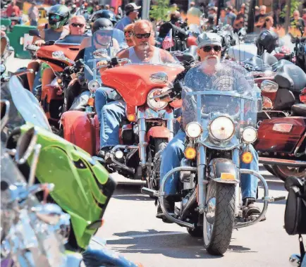 ?? JIM HOLLAND/AP ?? Motorcycli­sts ride through Sturgis, S.D., on Aug. 2, 2019. A recent viral video of motorcycli­sts protesting in South Africa was claimed to be a gathering at Walter Reed Military Medical Center to pray for President Donald Trump.