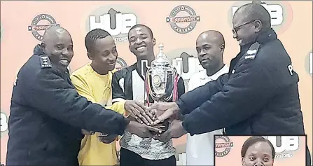  ?? (Pics: Machawe Fakudze) ?? Royal Leopard PRO Frank Hurube (L) smiles as he receives the trophy from EWFL Lucky Dube (R) with the team’s players. (Inset) Hub Utility Stores’ Khumbuzile Dlamini making her remarks.