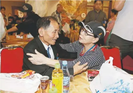  ?? Korea pool photo ?? South Korean Kim Hye-ja, 75, right, meets with her North Korean younger brother, Kim Eun Ha, 75, in North Korea on Tuesday. Dozens of elderly South Koreans crossed the heavily fortified border into North Korea for meetings with relatives that most hadn’t seen since they were separated by the turmoil of the Korean War.