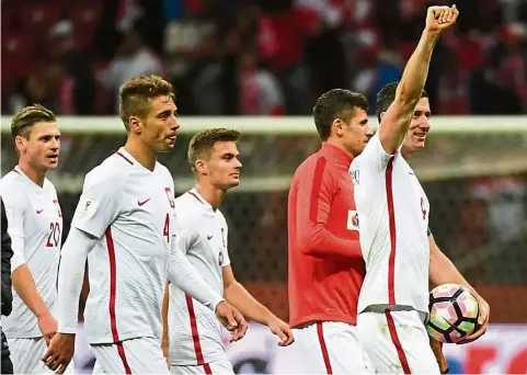  ?? — EPA ?? Leading by example: Poland captain Robert Lewandowsk­i (right) and teammates celebrate after beating Denmark 3-2 in the World Cup qualifier in Warsaw on Saturday.