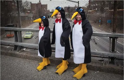  ?? (Andrew Kelly/Reuters) ?? GIRL OR penguin? in costume on an overpass on Purim in South Williamsbu­rg, New York, 2014.