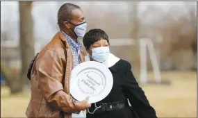  ?? (NWA Democrat-Gazette/David Gottschalk) ?? D’Andre Jones (left), Fayettevil­le City Council member, receives an award Monday from Sheree Miller during the Martin Luther King Jr. Unity Love Creation celebratio­n at Luther George Park in Springdale.