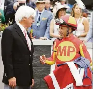  ?? Gregory Payan / Associated Press ?? The Kentucky Derby leads off the first Triple Crown season in decades without the chance of Bob Baffert, left, officially winning one or more of the three races. Baffert’s absence while suspended shadows over the race particular­ly because two horses he trained for a significan­t period of time are among the top contenders.