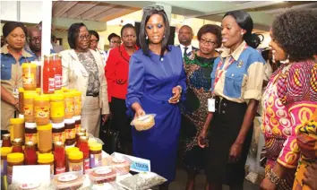  ??  ?? First Lady Amai Grace Mugabe views local products on display at the Ministry of Women Affairs, Gender and Community Developmen­t stand at the Harare Agricultur­al Show held in August