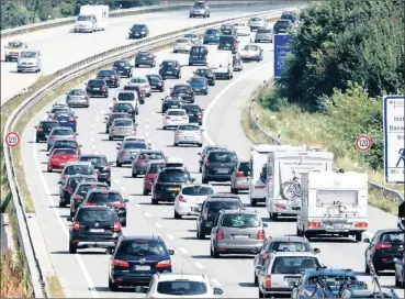  ?? PHOTO: AP ?? Vehicles are stuck in a traffic jam in Germany. The writer says businesses are incorporat­ing climate change into their internal decision making processes by adopting methods which are more energy efficient or seek to reduce greenhouse gas emissions.