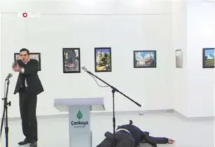  ?? (Screenshot) ?? A GUNMAN stands over the body of the Russian ambassador to Turkey after shooting him at an art gallery in Ankara yesterday.