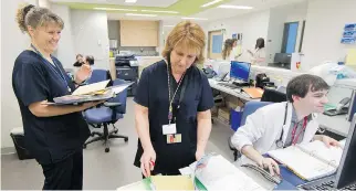  ??  ?? Nurses Elise Granger, left, and Marie Dupuis, and physician Alexandre Bazinet work at the hematology-oncology station at the new Glen site of the McGill University Health Centre on Wednesday.