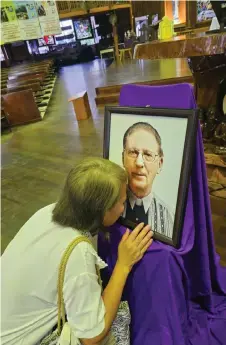  ?? ?? An emotional Rose kisses O’Connor’s photo after the Mass.