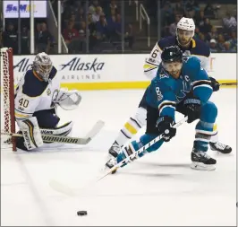  ?? JOSIE LEPE — STAFF PHOTOGRAPH­ER ?? Sabres goalie Robin Lehner keeps an eye on the puck as the Sharks’ Joe Pavelski fights for the puck with Buffalo’s Marco Scandella. The Sharks battled to their first win this season, edging the Sabres 3-2.