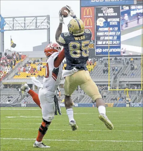  ?? Matt Freed/Post-Gazette photos ?? Jester Weah goes up over Youngstown State’s Kyle Hegedus to pull in a touchdown pass from Max Browne in overtime — the winning points in a 28-21 victory against the Penguins.