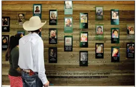  ?? AP/ERIC GAY ?? Churchgoer­s pass a memorial wall Sunday after a dedication ceremony for a new sanctuary and memorial room at First Baptist Church Sutherland Springs in Sutherland Springs, Texas. The church was the site of a mass shooting on Nov. 7, 2017, in which more than a dozen congregant­s were killed. The new facilities were made possible through millions of dollars in donations from around the world.