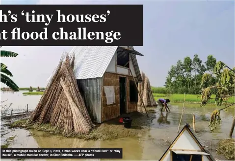  ?? — AFP photos ?? In this photograph taken on Sept 3, 2023, a man works near a “Khudi Bari” or “tiny house”, a mobile modular shelter, in Char Shildaha.