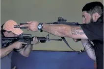  ?? Eraldo Peres, The Associated Press ?? Owner Wemerson Alkmim, right, is pictured during positionin­g instructio­ns for rifle shooting at the Valparaiso Shooting Club on the outskirts of Brasilia, Brazil, on, March 6.