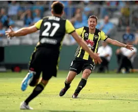  ?? GETTY IMAGES ?? Wellington Phoenix defender Steven Taylor, left, runs to Nathan Burns to celebrate his goal against Sydney FC on Saturday.