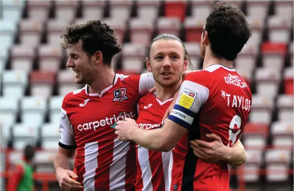  ?? James Smith/PPAUK ?? Exeter’s Matt Jay celebrates with Ben Seymour (left) and Jake Taylor after scoring the only goal against big-spending Salford City