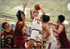  ?? ?? Los Gatos' Tommy Ankenbrand­t (14) shoots the ball in the first half around four Cupertino defenders.