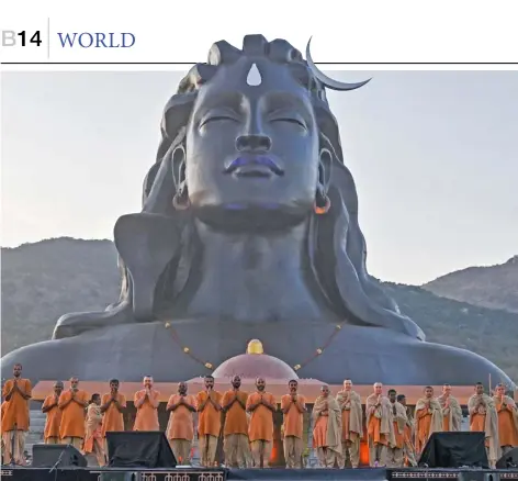  ?? MANJUNATH KIRAN/AGENCE FRANCE-PRESSE ?? FOLLOWERS of India’s spiritual guru and founder of Isha Foundation, Jagadish ‘Jaggi’ Vasudev, popularly known as Sadhguru, offer prayers in front of the 112-feet tall bust of 'Adiyogi,’ another name for Hindu God Shiva, during its unveiling at Isha Foundation's new center in Chikkaball­apur, about 70 kilometers north of Bangalore, India.