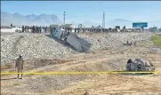  ?? AFP ?? A security official stands guard at the site of a suicide bomb attack targeting a police truck in Quetta.