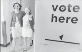  ?? Stuart Gradon, Calgary Herald ?? Progressiv­e Conservati­ve Leader Alison Redford, with her daughter Sarah, casts her ballot, right, and leaves the polling station at Lycee Louis Pasteur school in Calgary.