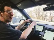  ?? Will Haskell / Contribute­d photo ?? Columnist Dan Haar at the wheel of the new Rivian pickup truck in Hartford on Wednesday.