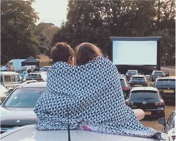  ??  ?? People under blankets watching drive-in movie (photo: CH Cinema)