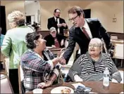  ?? NUCCIO DINUZZO/CHICAGO TRIBUNE ?? Republican U.S. Rep. Peter Roskam shakes hands with Sandra Correa at a meeting in Wheaton on Oct. 10.