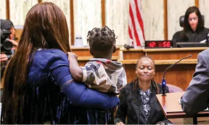  ??  ?? A woman and her child are called up during a special court hearing in Miami, aimed at restoring the right to vote under Florida’s amendment 4. Photograph: Zak Bennett/AFP via Getty Images