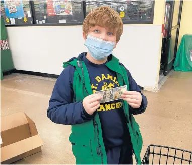  ?? DANIELLE PIERCE ?? Remington Pierce, 7, of Crestwood, gets ready to spend $100 he received from Good Shepherd Church in Palos Heights on items for Blessing Bags for homeless people.