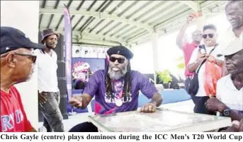  ?? ?? Chris Gayle (centre) plays dominoes during the ICC Men’s T20 World Cup promotiona­l event on Thursday in Barbados. (ICC)