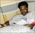  ??  ?? Rayshard Brooks holds his newborn daughter in this undated photo. There is speculatio­n he fought police because he feared being arrested would send him to prison for violating parole.