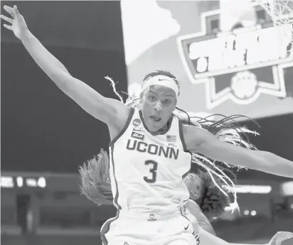  ?? CARMEN MANDATO/GETTY ?? UConn’s Aaliyah Edwards is pushed out of bounds against the Iowa Hawkeyes during the Sweet 16 round of the NCAA Women’s Basketball Tournament in March in San Antonio, Texas.