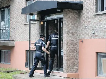  ?? ALLEN McINNIS / MONTREAL GAZETTE ?? Montreal police investigat­e on Monday a building where a pregnant woman was stabbed. A neighbour said she heard the couple arguing frequently during the eight months they lived in the building.