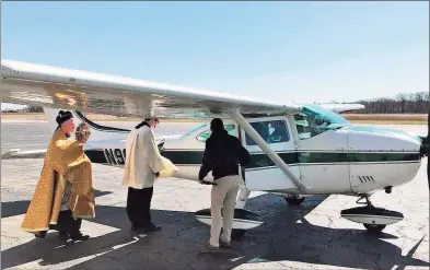  ?? Contribute­d photo ?? The Rev. Brian Gannon of St. Theresa Roman Catholic Church in Trumbull and the Rev. Flavian Bejan, associate pastor, prepare to board a Cessna 172 plane at Sikorsky Memorial Airport before flying over the Bridgeport Diocese to bestow blessings on March 24, 2020.