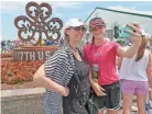  ??  ?? Makayla Black, 13, takes a photo Wednesday with her mother, Michelle Braatz, of Rosemary Beach, Fla., and formerly of Hartford, in front of the shamrock sculpture at Erin Hills. The sculpture was made by a Milwaukee blacksmith. See video at...